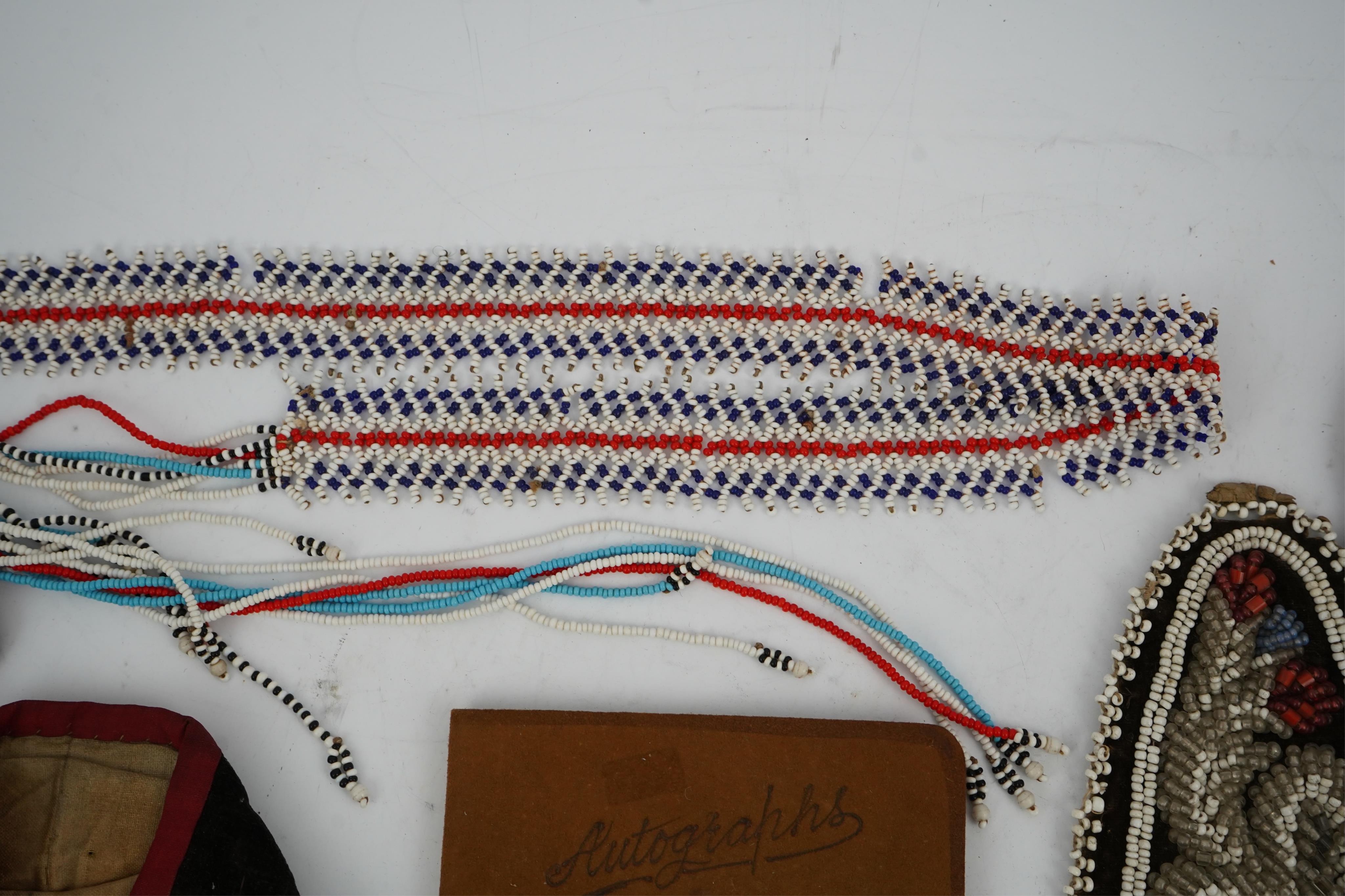 A collection of mixed decorative bead work, including five items of Native American beadwork, together with an early beadwork bag and later beaded items. Condition - moccasins, bead panel, circular bed purse with metal l